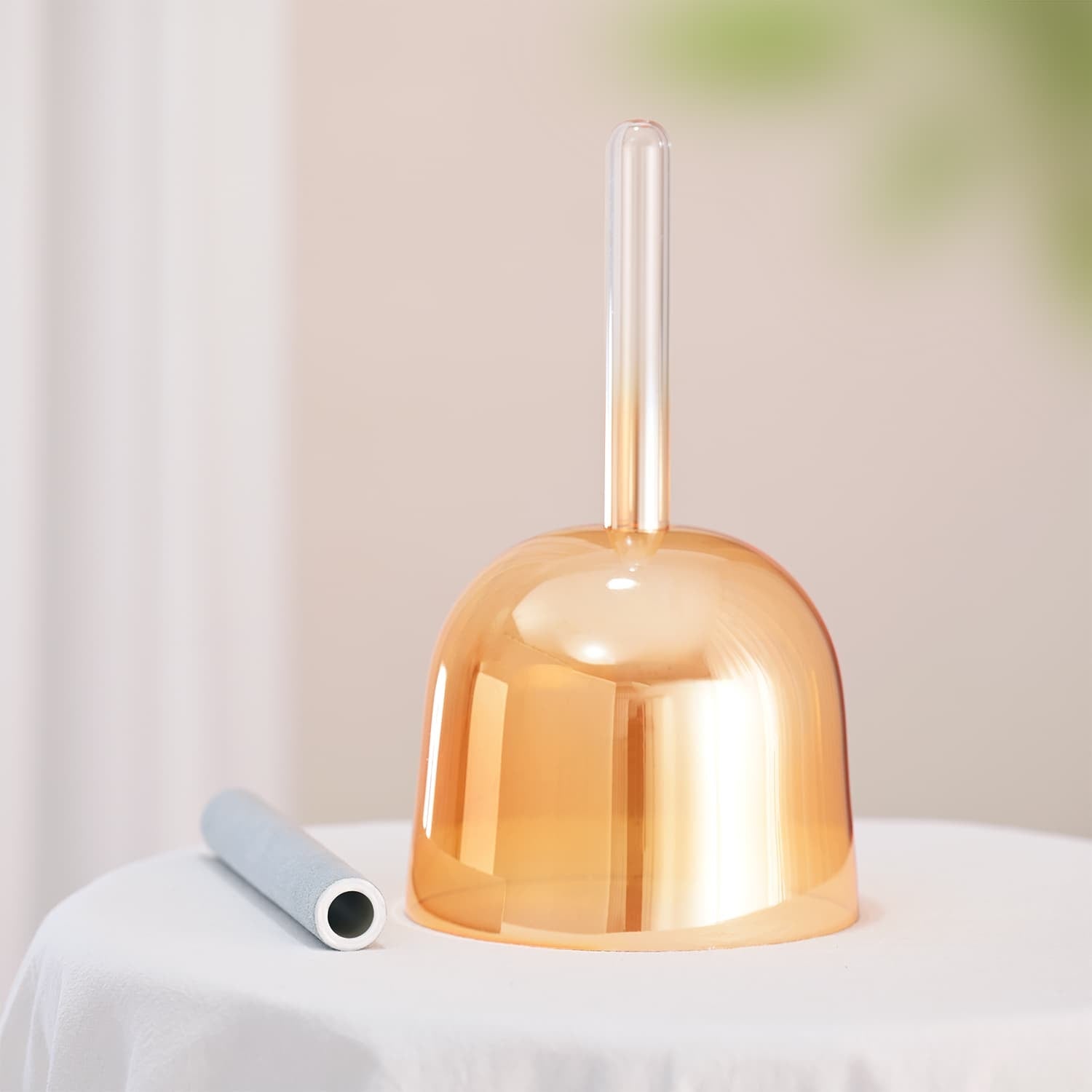 Metallic copper bell with clear plastic handle for 6 inch F Note Crystal Singing Bowl