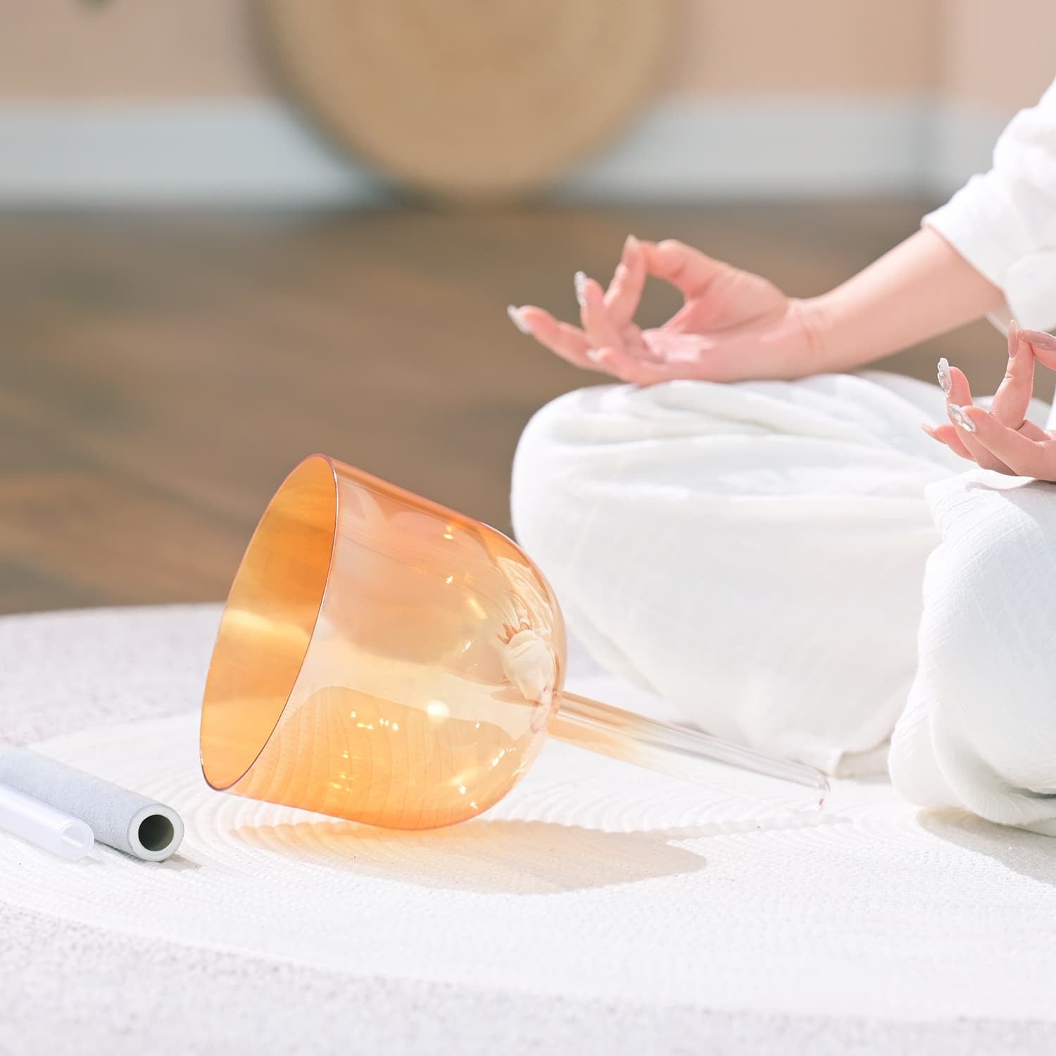 Orange crystal singing bowl on its side, ideal for sound healing and meditation