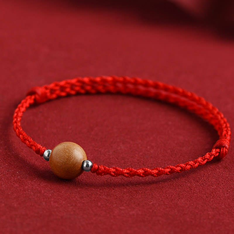 6 mm Schutzarmband aus Pfirsichholz mit roter Schnur