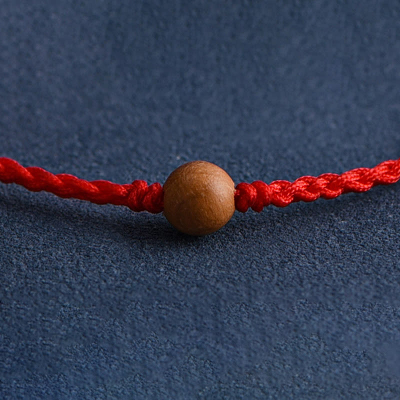 6 mm Schutzarmband aus Pfirsichholz mit roter Schnur