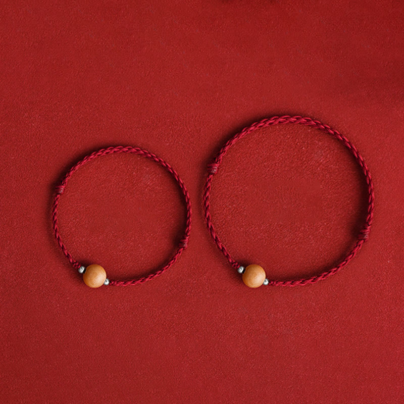 6 mm Schutzarmband aus Pfirsichholz mit roter Schnur