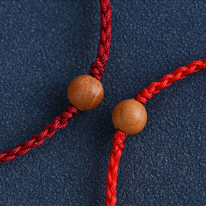 6 mm Schutzarmband aus Pfirsichholz mit roter Schnur