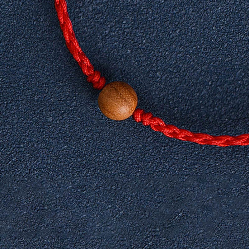 6 mm Schutzarmband aus Pfirsichholz mit roter Schnur