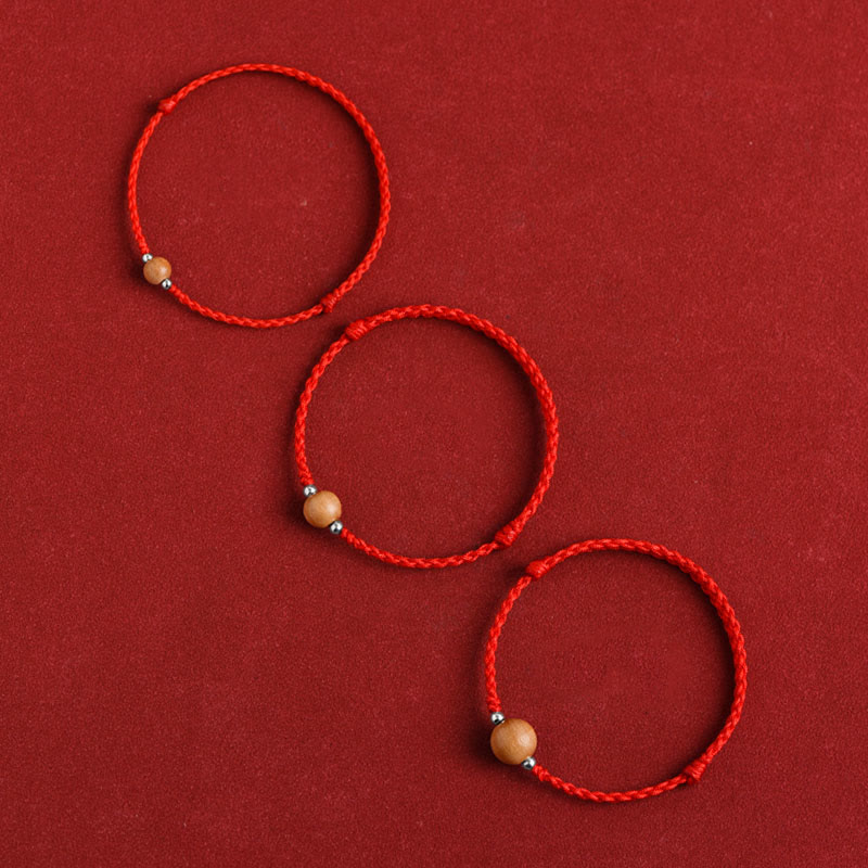 6 mm Schutzarmband aus Pfirsichholz mit roter Schnur