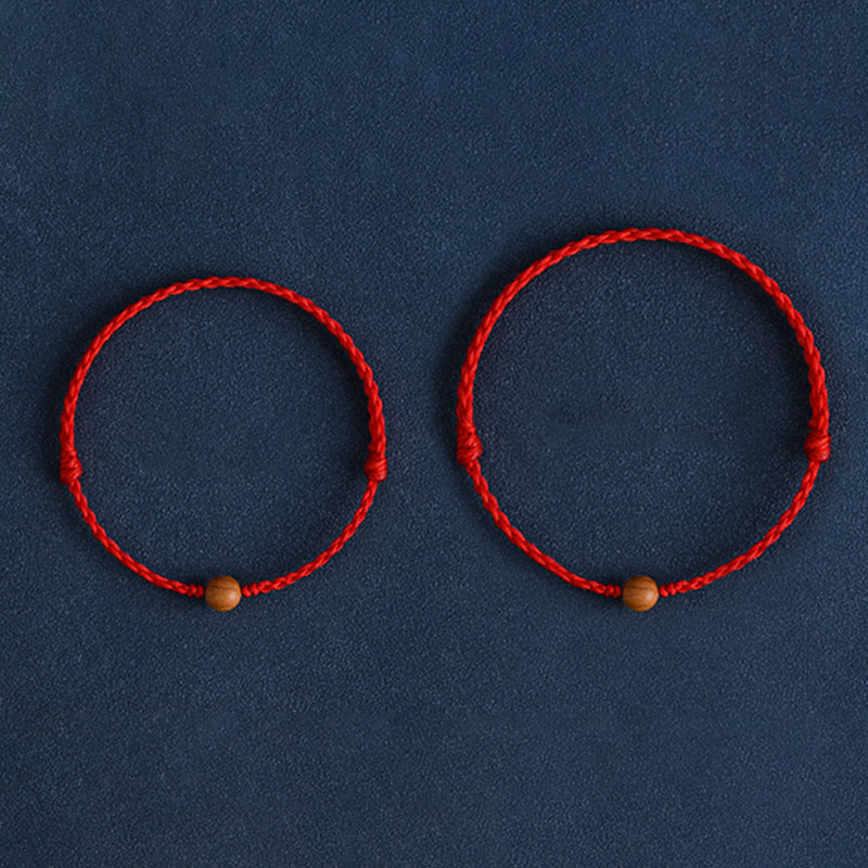 6 mm Schutzarmband aus Pfirsichholz mit roter Schnur