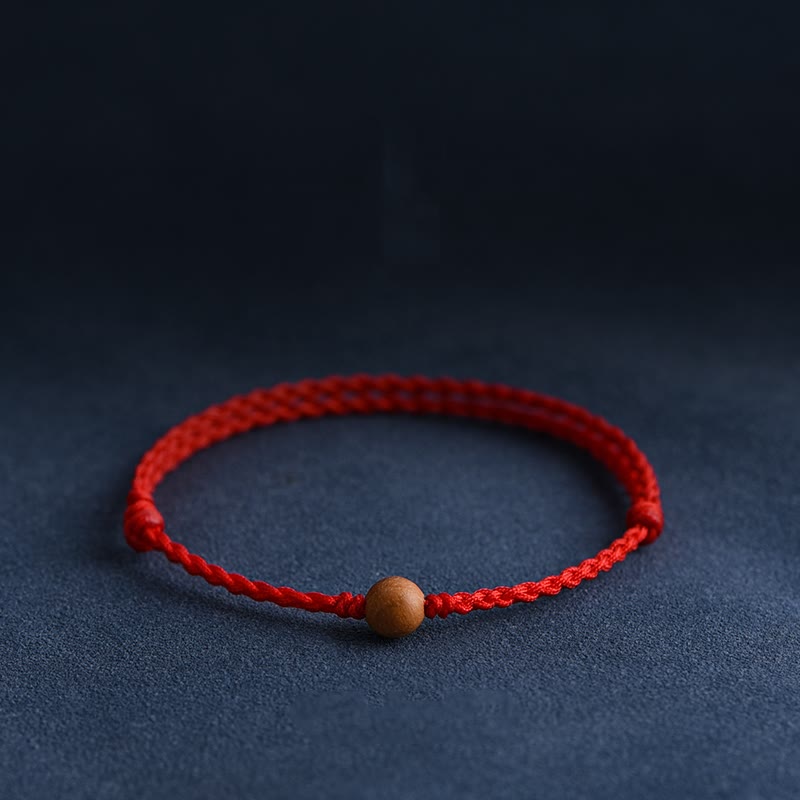6 mm Schutzarmband aus Pfirsichholz mit roter Schnur