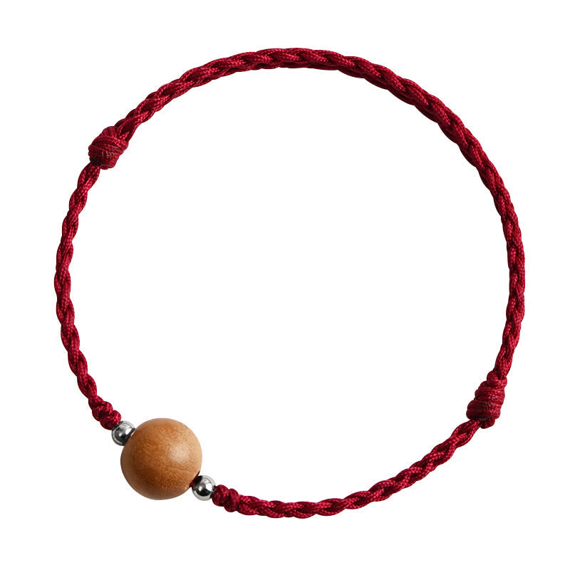 6 mm Schutzarmband aus Pfirsichholz mit roter Schnur