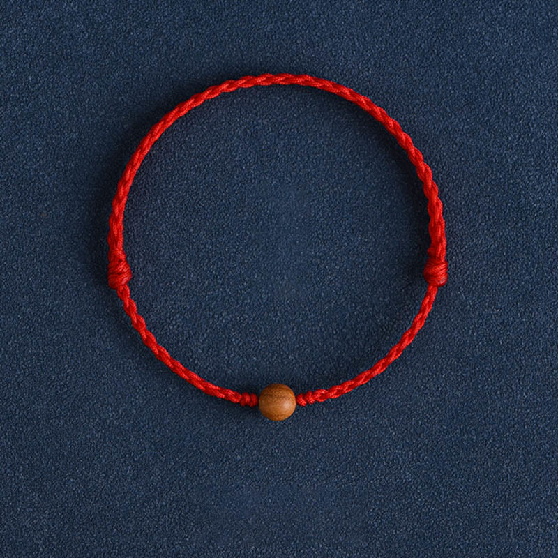 6 mm Schutzarmband aus Pfirsichholz mit roter Schnur