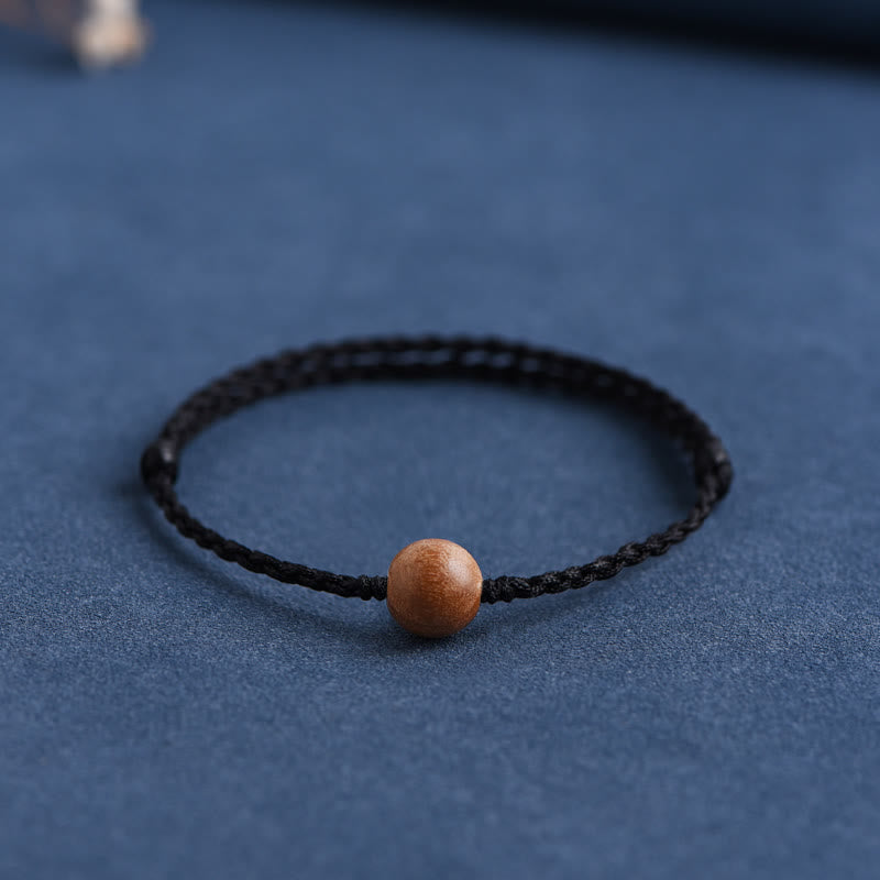 6 mm Schutzarmband aus Pfirsichholz mit roter Schnur