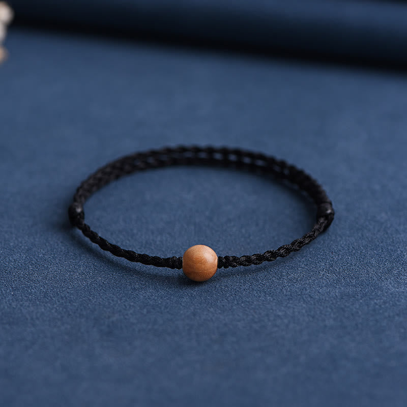 6 mm Schutzarmband aus Pfirsichholz mit roter Schnur