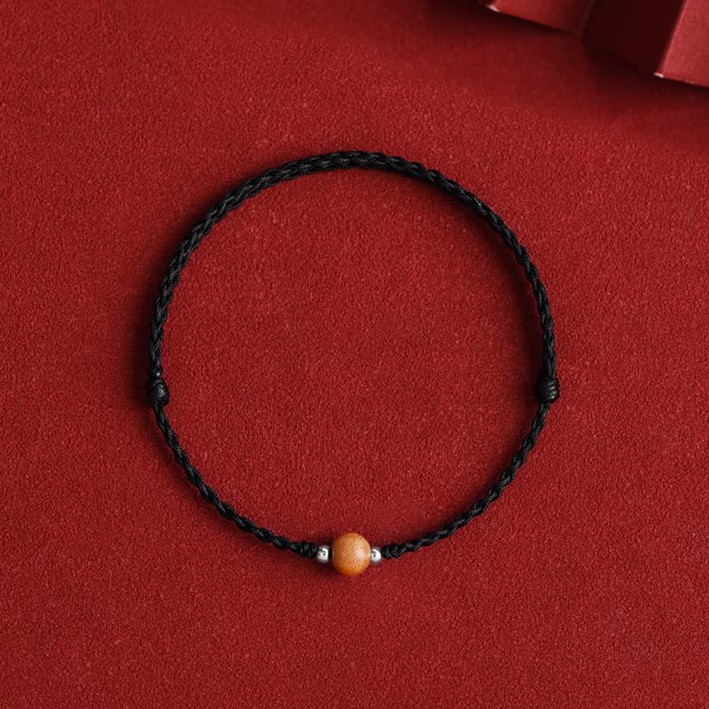 6 mm Schutzarmband aus Pfirsichholz mit roter Schnur