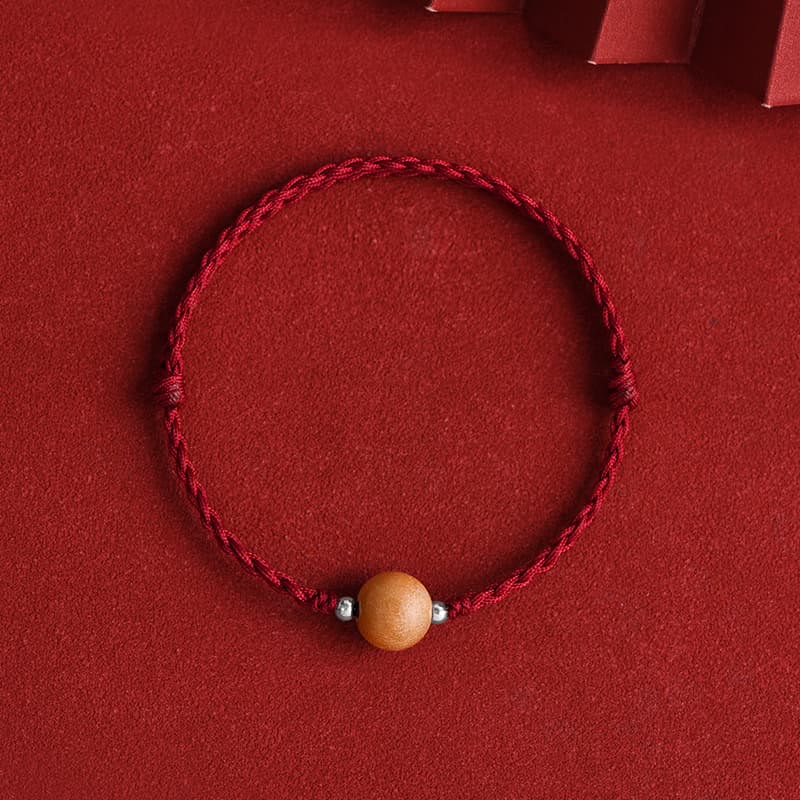 6 mm Schutzarmband aus Pfirsichholz mit roter Schnur