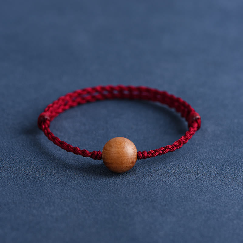 6 mm Schutzarmband aus Pfirsichholz mit roter Schnur