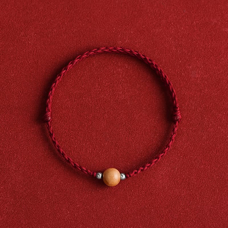 6 mm Schutzarmband aus Pfirsichholz mit roter Schnur