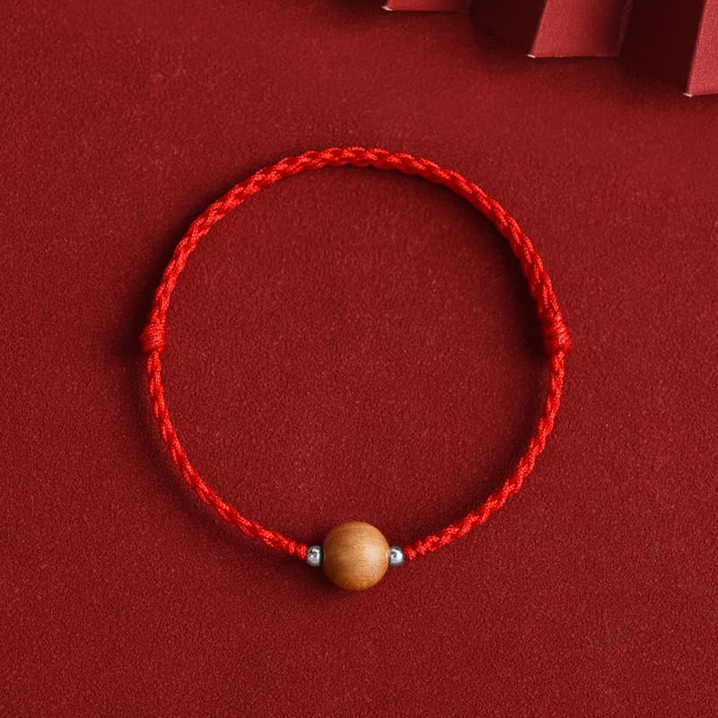 6 mm Schutzarmband aus Pfirsichholz mit roter Schnur