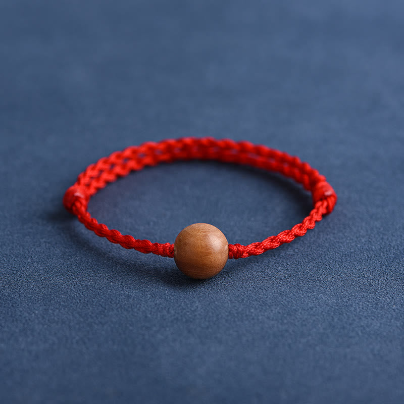 6 mm Schutzarmband aus Pfirsichholz mit roter Schnur