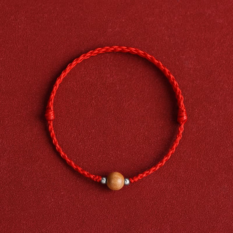 6 mm Schutzarmband aus Pfirsichholz mit roter Schnur