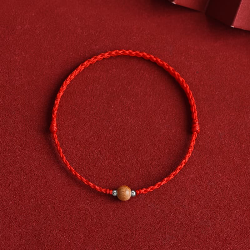 6 mm Schutzarmband aus Pfirsichholz mit roter Schnur