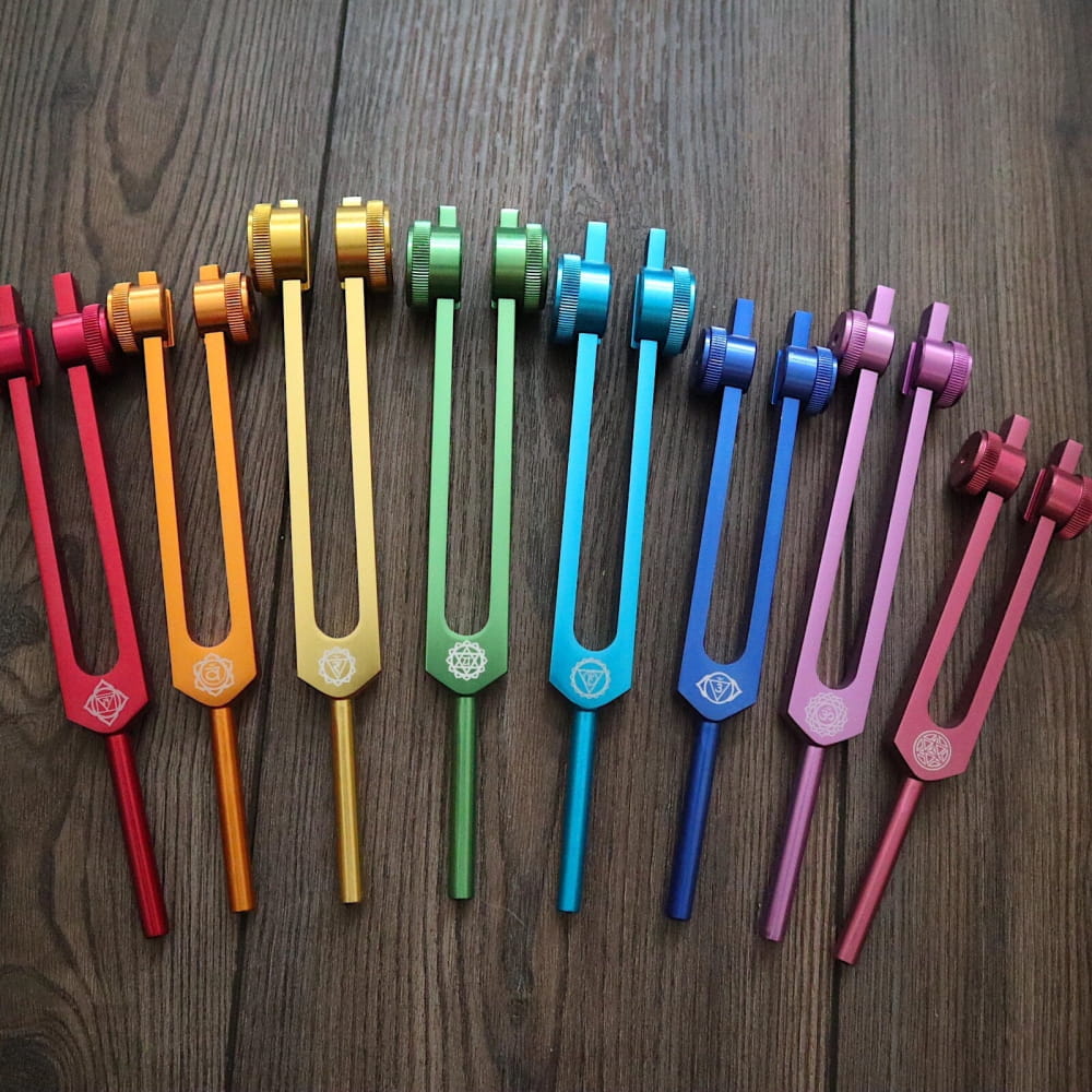 Colorful tuning forks arranged in a rainbow for Chakra Healing Tuning Fork Set