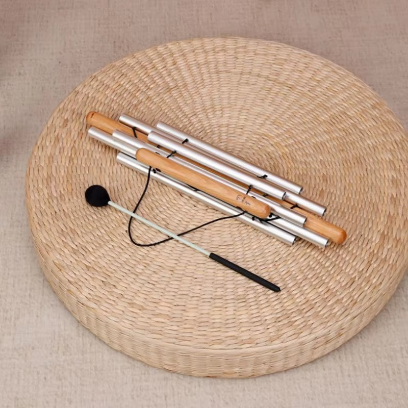 Bamboo and aluminum meditation chime on a woven mat for Yoga Sound Therapy