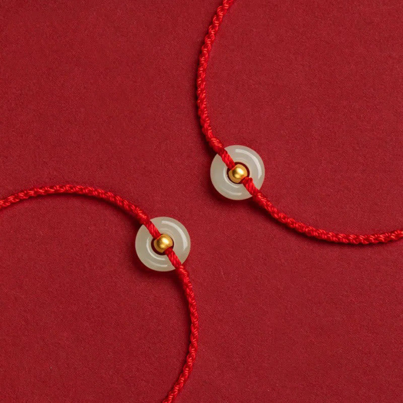 Glücksarmband aus 999er Goldperlen aus Hetian-Jade mit Friedensschnalle