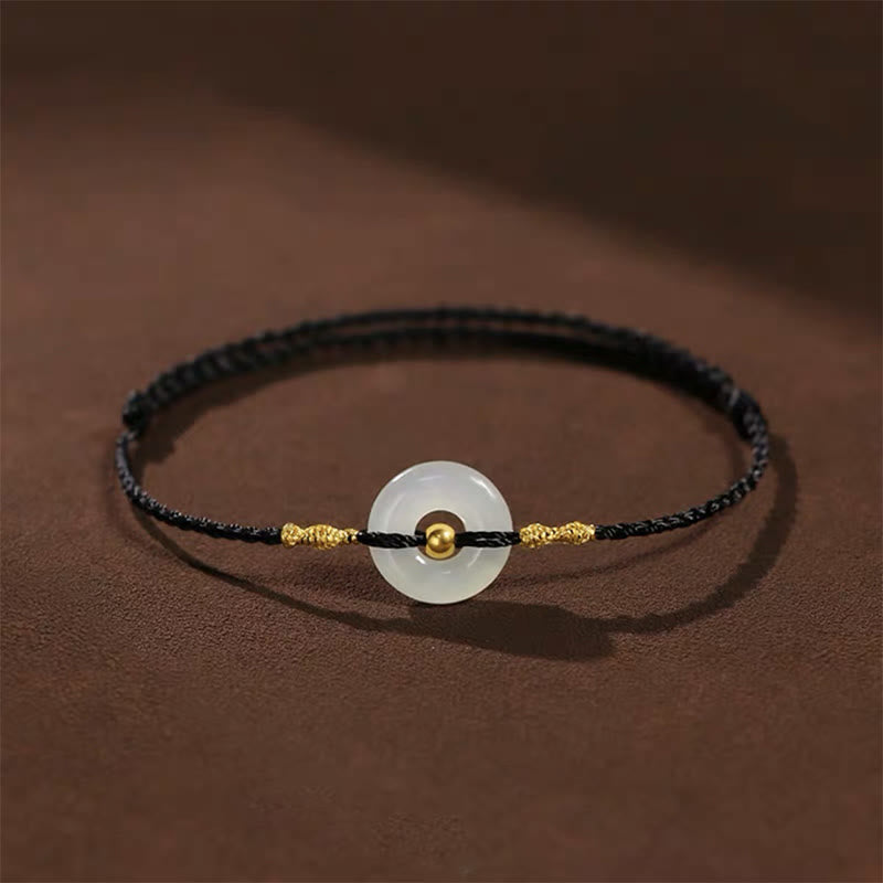 Glücksarmband aus 999er Goldperlen aus Hetian-Jade mit Friedensschnalle