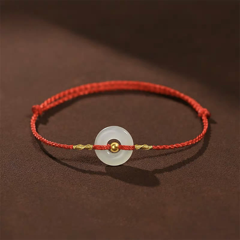 Glücksarmband aus 999er Goldperlen aus Hetian-Jade mit Friedensschnalle