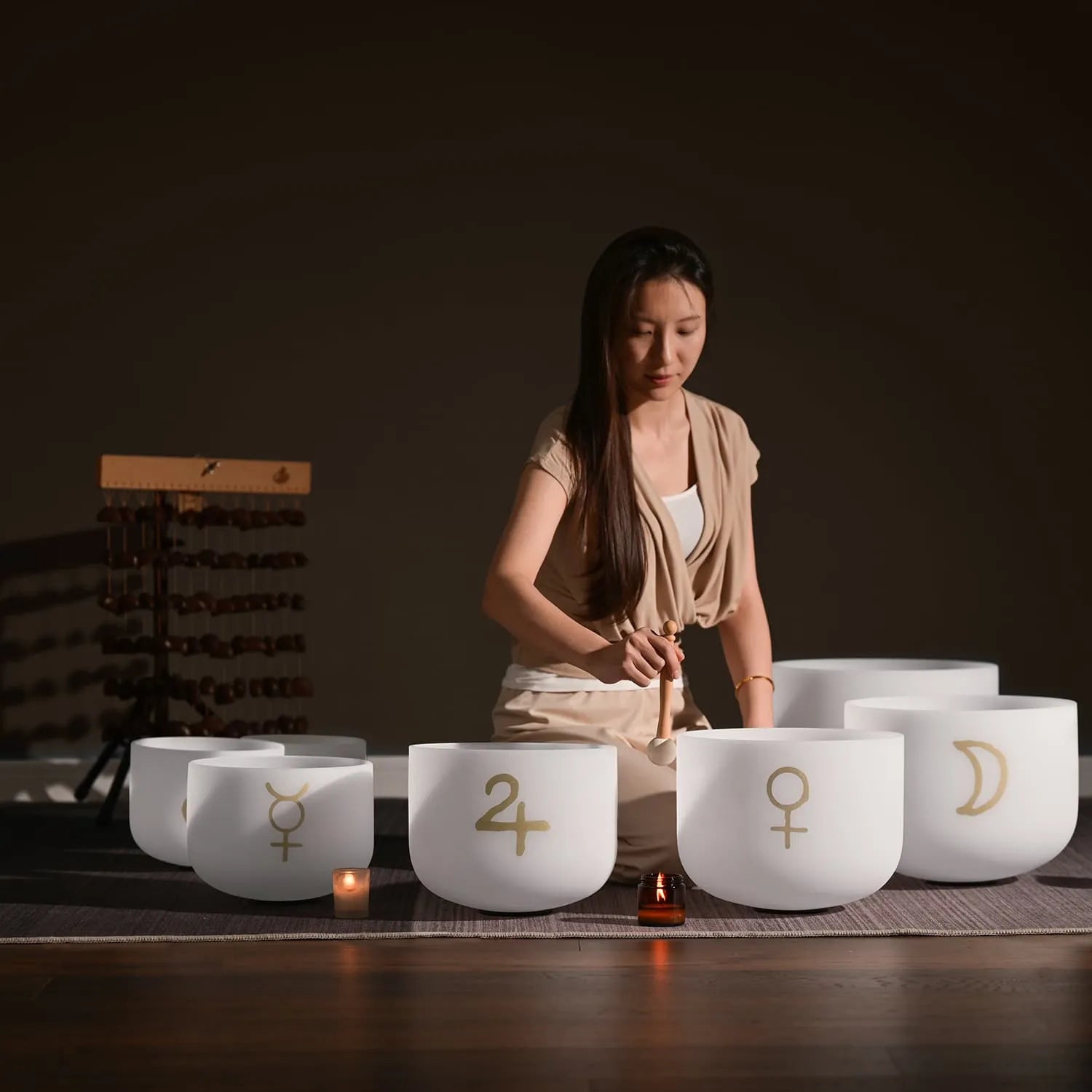 White Crystal Singing Bowl Set with Astrological Symbols on Display Surface