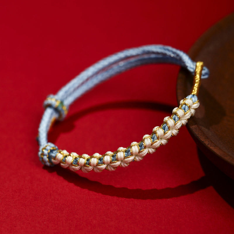 Verstellbares Armband aus rotem tibetischem Goldfaden mit Pfirsichblütenknoten