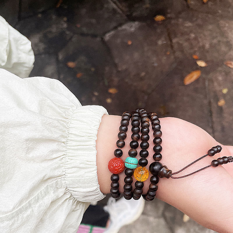 Adlerholzarmband mit türkisfarbenem Bernstein und rotem Achat für Stärke