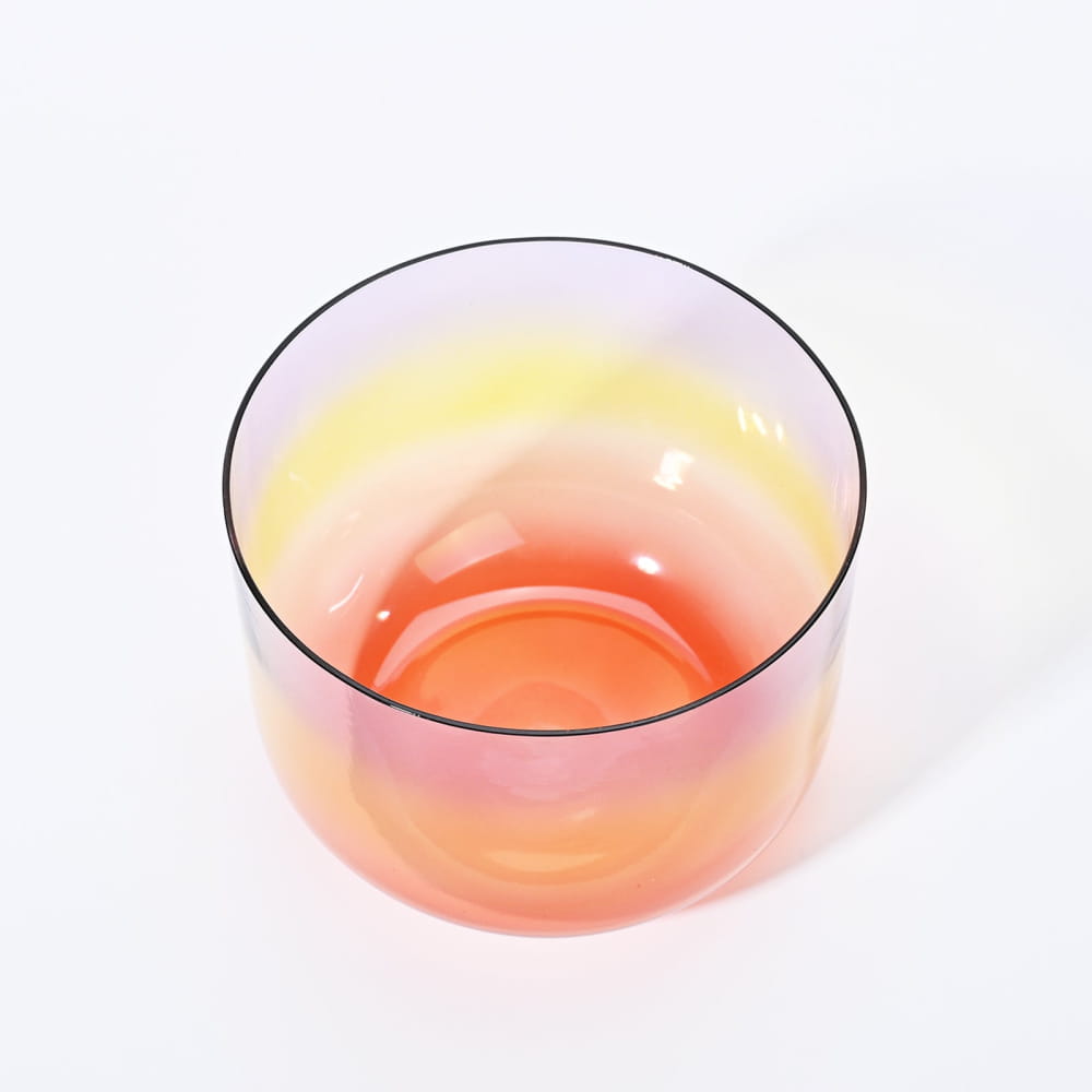 Clear glass bowl with orange-pink liquid in Alchemy Clear Rainbow B Note Crystal Singing Bowl