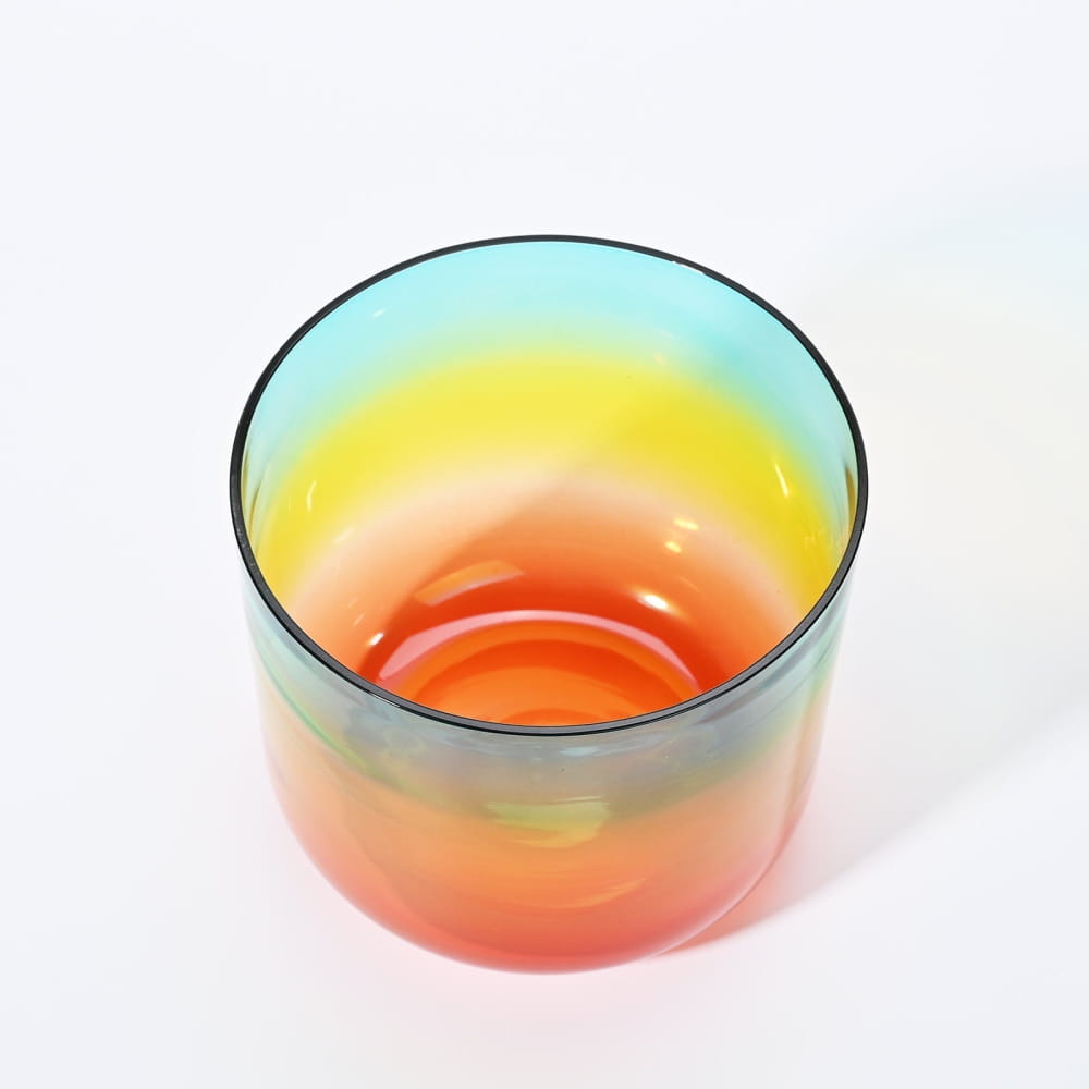 Rainbow-colored glass bowl featuring a gradient from red to blue in Alchemy Clear G Note