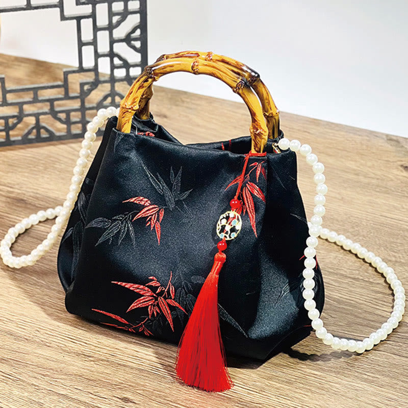 Schwarze Tasche aus Polyester-Baumwolle mit bestickten Blättern und Bambusgriff