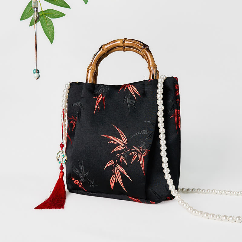Schwarze Tasche aus Polyester-Baumwolle mit bestickten Blättern und Bambusgriff