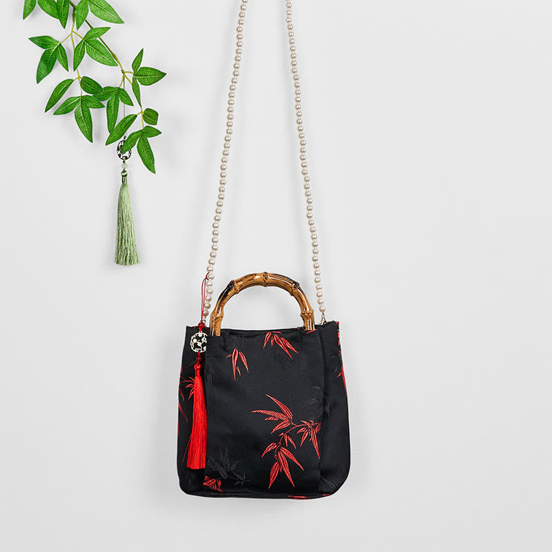 Schwarze Tasche aus Polyester-Baumwolle mit bestickten Blättern und Bambusgriff