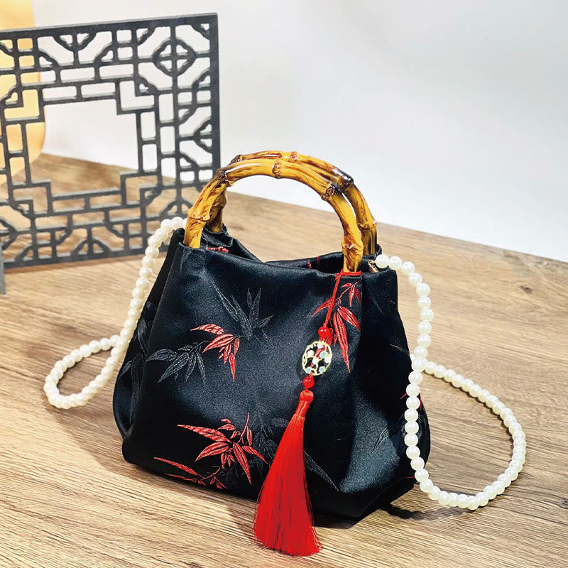 Schwarze Tasche aus Polyester-Baumwolle mit bestickten Blättern und Bambusgriff