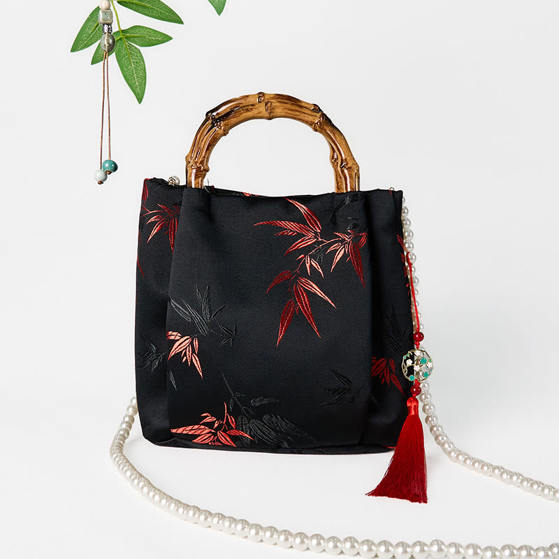 Schwarze Tasche aus Polyester-Baumwolle mit bestickten Blättern und Bambusgriff