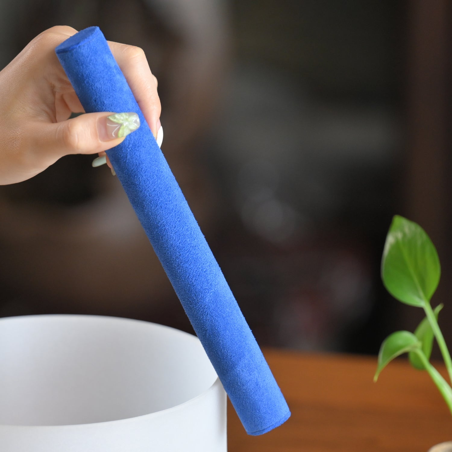 Bright blue foam pool noodle held by a hand for use with Blue Suede Mallet