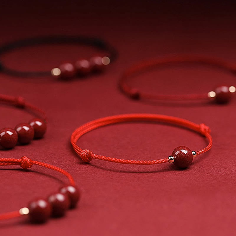 Zinnoberarmband und Fußkettchen mit Glücksbringerschnur