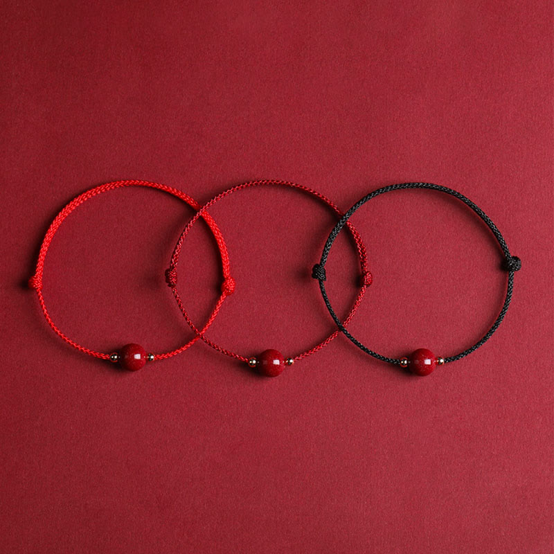 Zinnoberarmband und Fußkettchen mit Glücksbringerschnur