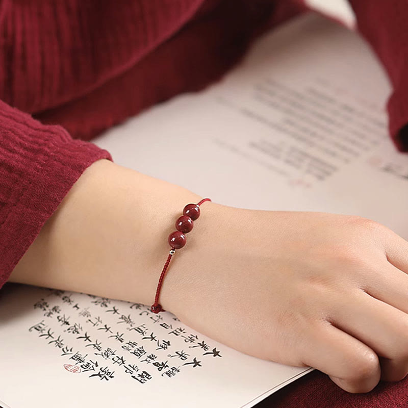 Zinnoberarmband und Fußkettchen mit Glücksbringerschnur