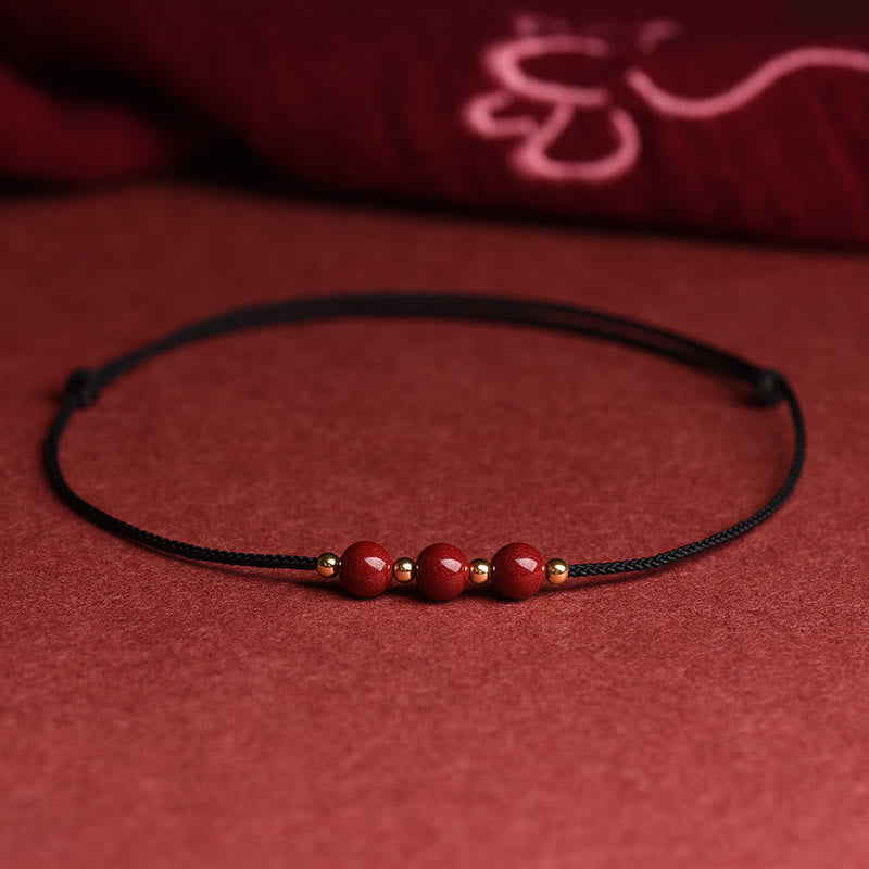 Zinnoberarmband und Fußkettchen mit Glücksbringerschnur