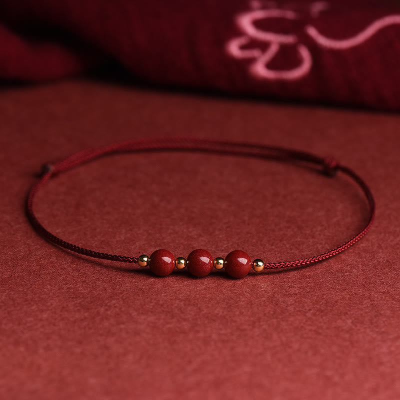 Zinnoberarmband und Fußkettchen mit Glücksbringerschnur