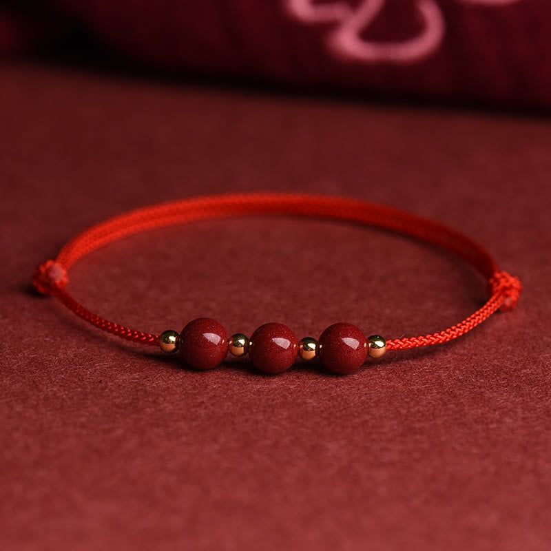 Zinnoberarmband und Fußkettchen mit Glücksbringerschnur