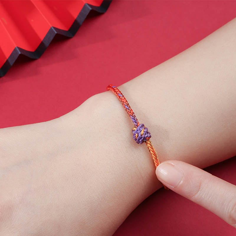 Buntes lila-goldrotes geflochtenes Seilarmband für Balance
