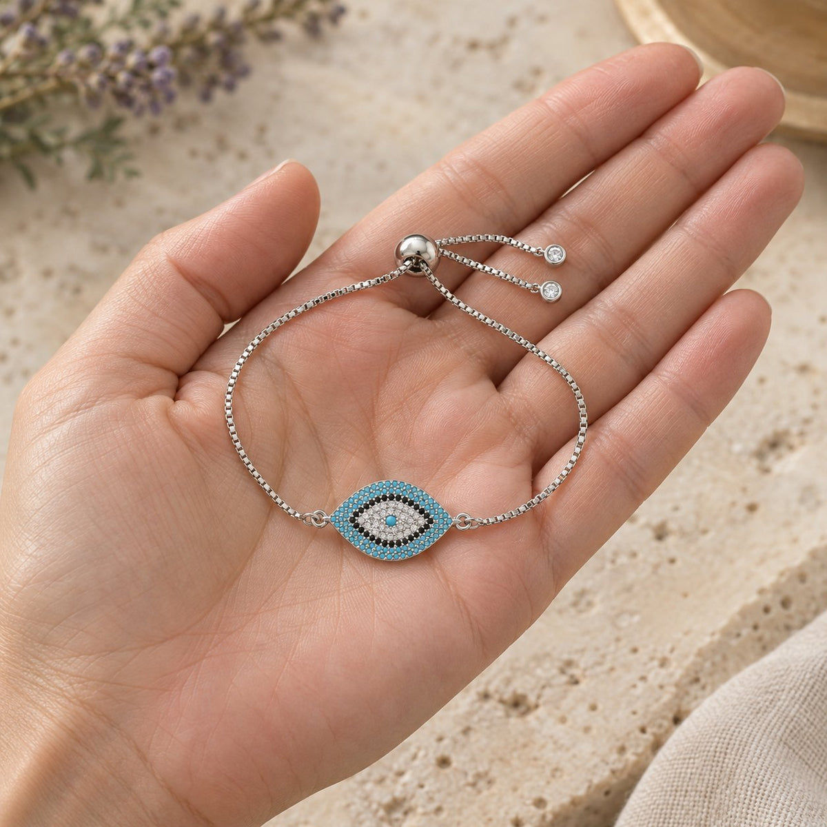 Copper Evil Eye Protection Bracelet, held in the hand to show its real size