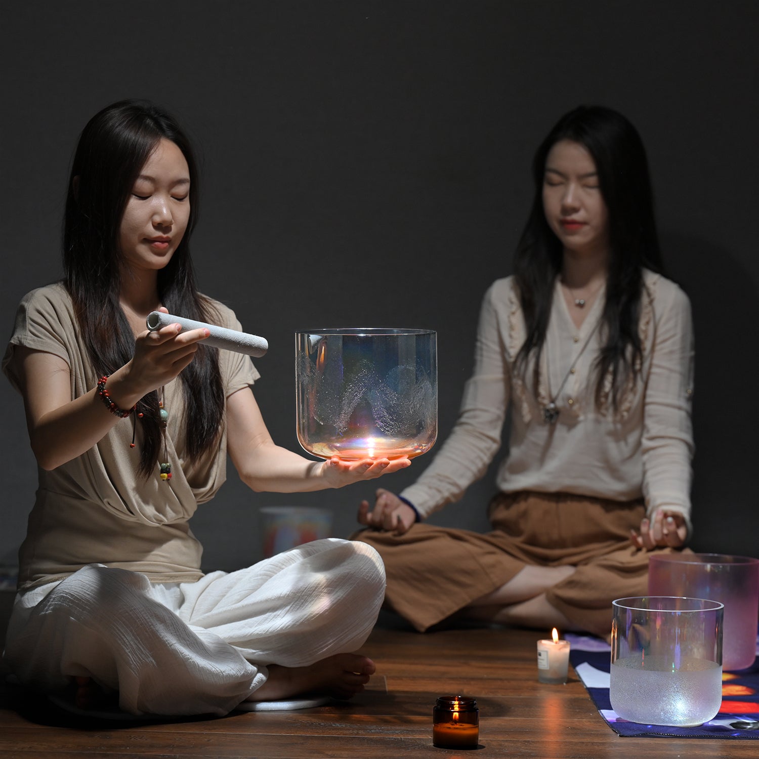 Glowing glass vessel with candlelight during meditative practice for sound healing