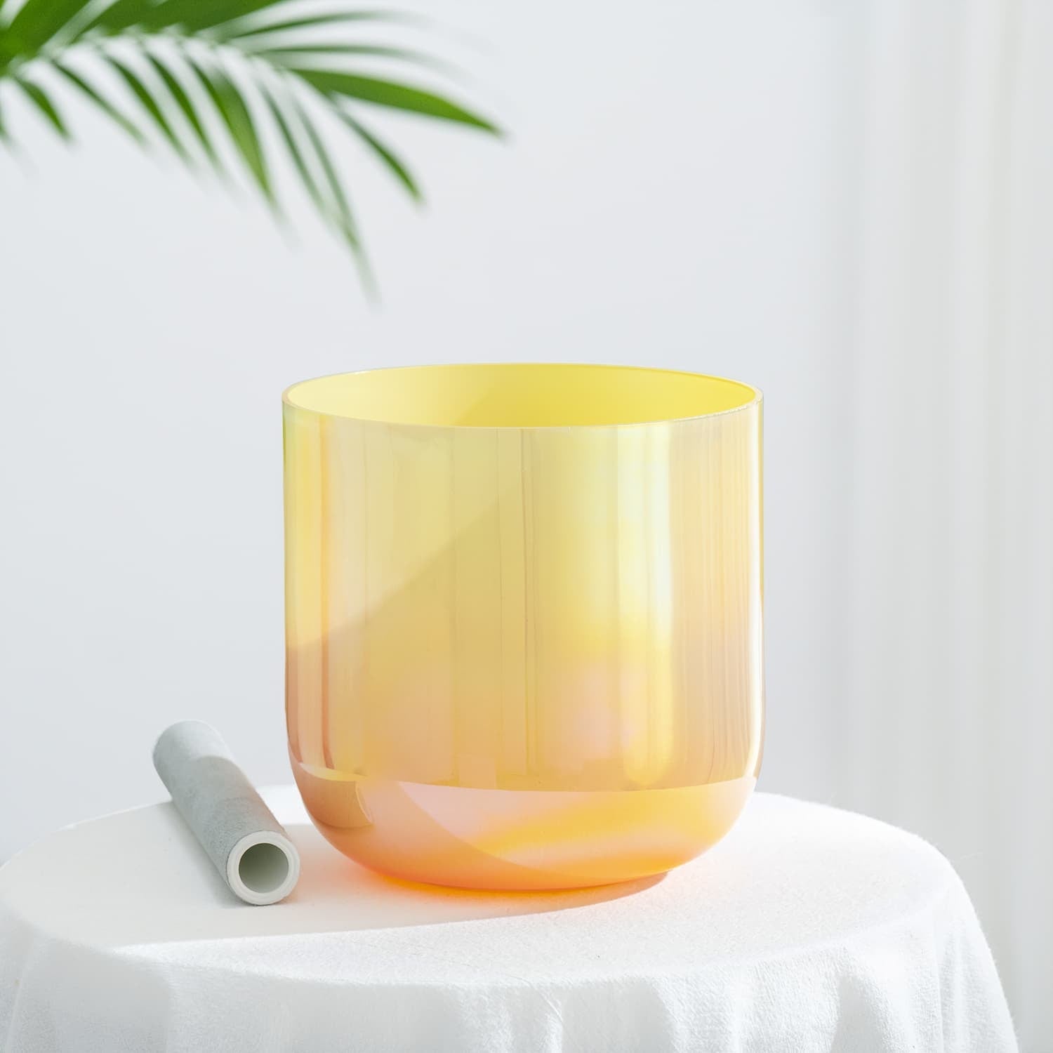 Yellow and orange gradient glass vessel in a cylindrical shape for sound healing