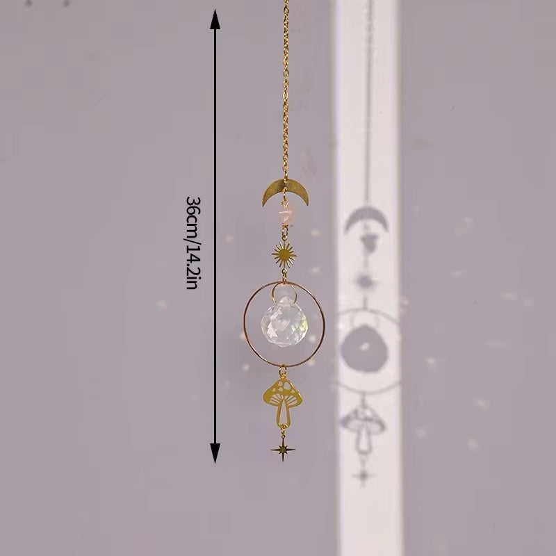 Decorative hanging crystal suncatcher with moon and mushroom charms on gold chain