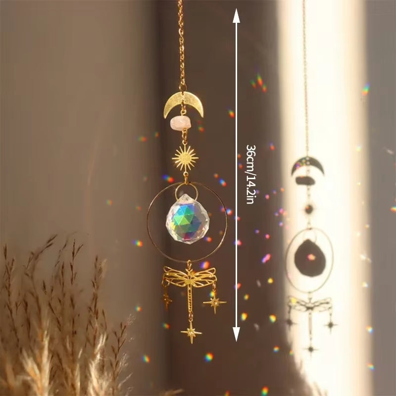 Hanging crystal suncatcher with golden moon, sun, dragonfly, and star decorations
